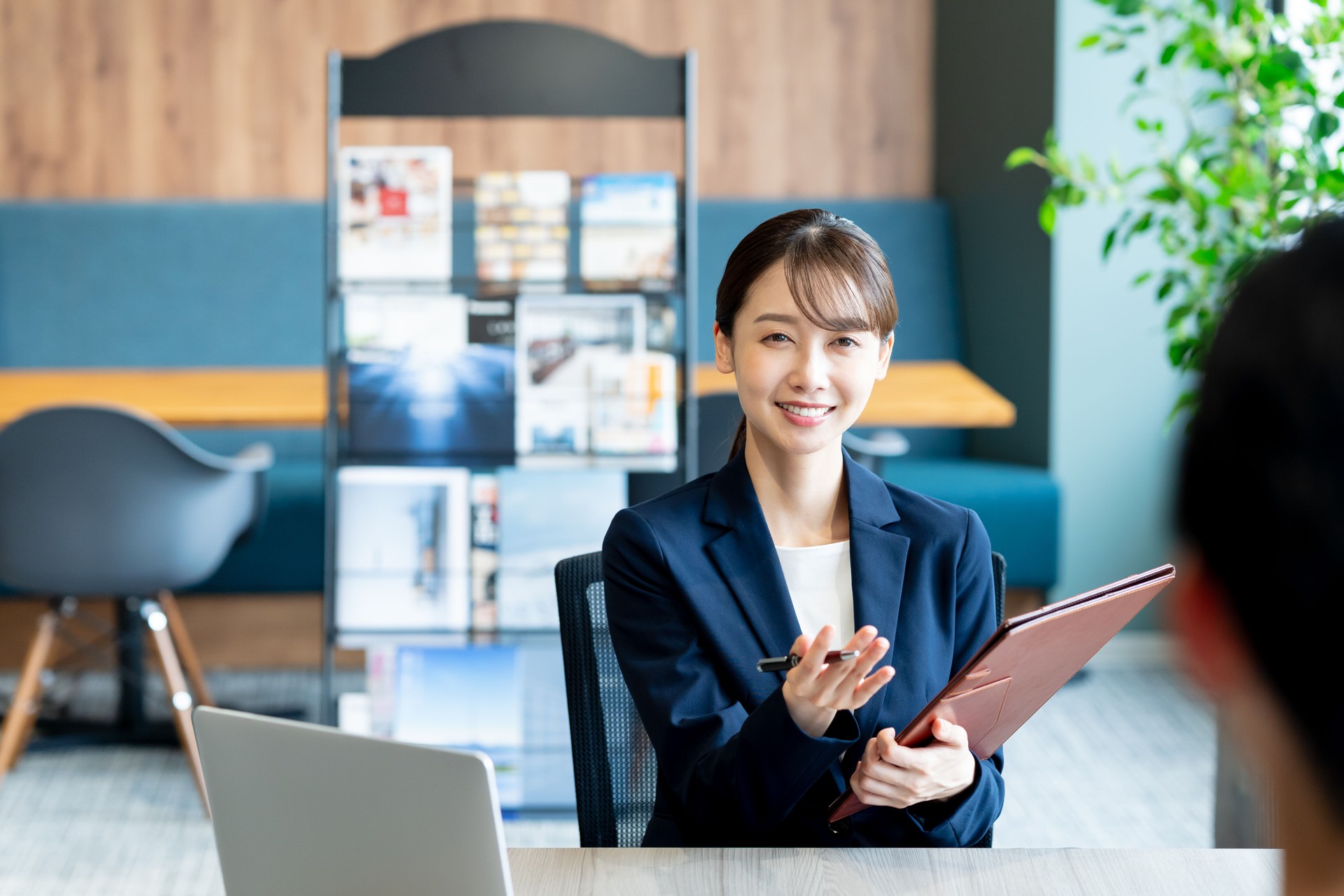A female consultant working at the reception desk